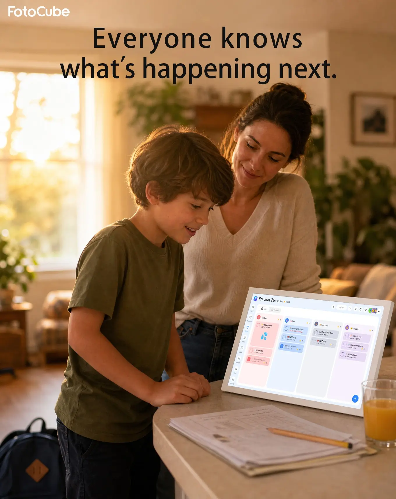 A parent and child using a FotoCube calendar in the kitchen